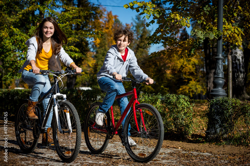 Photo: Urban biking - teens riding bikes in city Urban biking - teens riding bikes in city