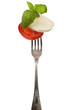 Foto: Caprese salad on silver fork isolated Caprese salad on silver fork isolated