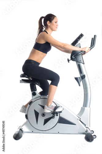 Photo: Slim brunette trains on velosimulator Slim brunette trains on velosimulator