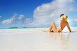 Photo: young beautiful woman relaxing on sand beach young beautiful woman relaxing on sand beach
