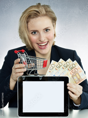 Photo: Business woman shopping on the internet with tablet pc Business woman shopping on the internet with tablet pc