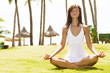 Photo: young woman meditating on natural background young woman meditating on natural background