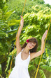 Photo: young beautiful woman swinging on natural background young beautiful woman swinging on natural background