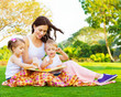 Woman with daughter and son read fairytale