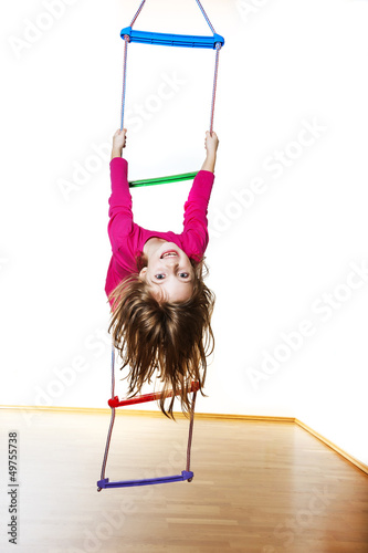 Photo: happy little girl climbing on a ladder happy little girl climbing on a ladder