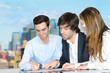 Successful young office team discussing over a document.