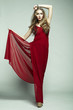 Fashion photo of young magnificent woman in red dress