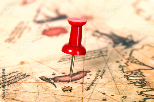 Photo: Thumbtack in the world map Thumbtack in the world map