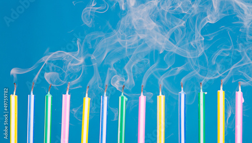 Photo: birthday candles in a row with smoke birthday candles in a row with smoke