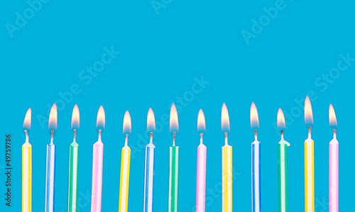 Photo: birthday candles in a row with flames birthday candles in a row with flames