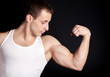 Photo: strong bodybuilder posing on black background strong bodybuilder posing on black background