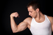 Photo: strong bodybuilder posing on black background strong bodybuilder posing on black background