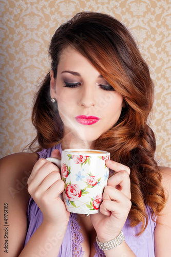 Photo: Cute Brunette Woman Drinking Hot Coffee Indoors Cute Brunette Woman Drinking Hot Coffee Indoors