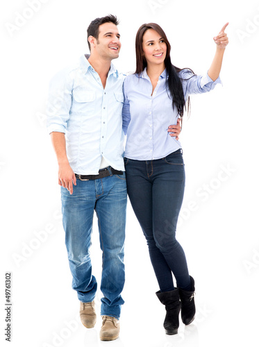 Photo: Happy couple pointing away Happy couple pointing away