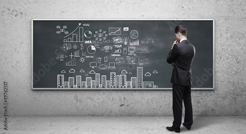 Photo: man looking at business strategy man looking at business strategy