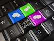 Social media on laptop keyboard. Conceptual image. 3d