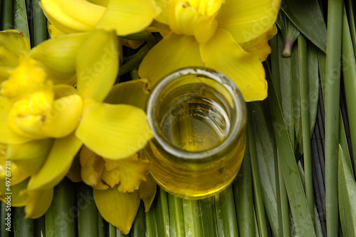 Photo: oil bottles and yellow orchid on bamboo grove oil bottles and yellow orchid on bamboo grove