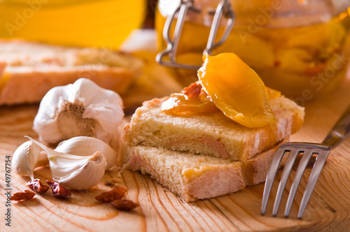Photo: Sliced bread with peppers under oil. Sliced bread with peppers under oil.