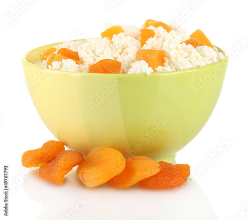 Photo: Cottage cheese in color bowl with apricot, isolated on white Cottage cheese in color bowl with apricot, isolated on white