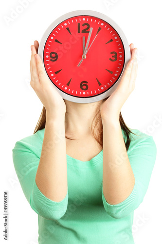 Photo: Girl holding clock over face isolated on white Girl holding clock over face isolated on white