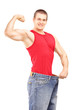 Weight loss man in an old pair of jeans showing his muscular bod