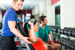 Photo: woman and Personal Trainer in gym, with dumbbells woman and Personal Trainer in gym, with dumbbells