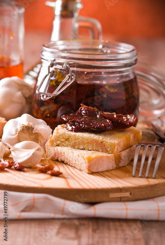 Photo: Sliced bread with dried tomato under oil. Sliced bread with dried tomato under oil.