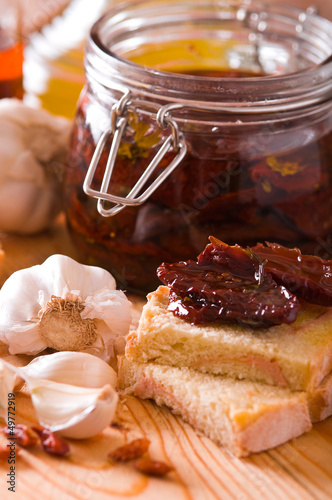 Photo: Sliced bread with dried tomato under oil. Sliced bread with dried tomato under oil.