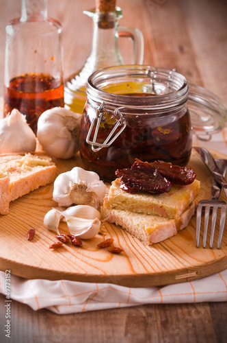 Photo: Sliced bread with dried tomato under oil. Sliced bread with dried tomato under oil.