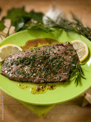 Photo: beef steack with garlic and mixed herbs, selective focus beef steack with garlic and mixed herbs, selective focus
