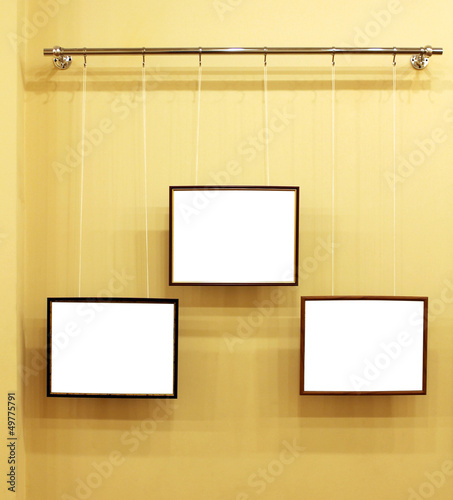 Photo: Three frames with isolated canvas on the exhibition ledge Three frames with isolated canvas on the exhibition ledge
