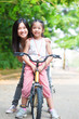 Asian family riding bike