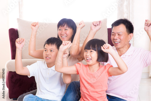 Photo: Asian family playing game at home. Asian family playing game at home.