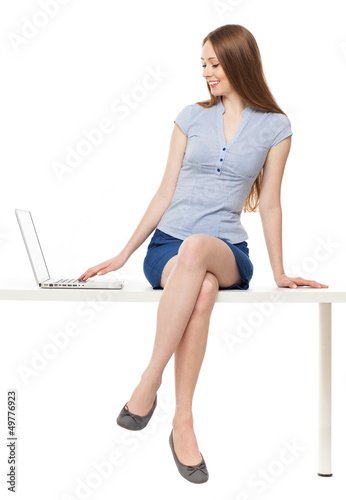 Photo: Woman sitting with a laptop Woman sitting with a laptop