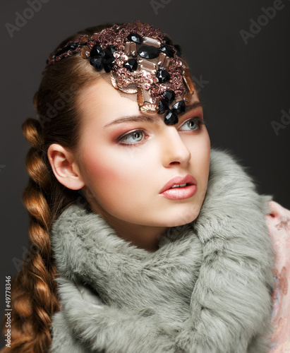 Photo: Braided Hair Luxurious Woman in Fur Collar and Gemstones. Jewels Braided Hair Luxurious Woman in Fur Collar and Gemstones. Jewels