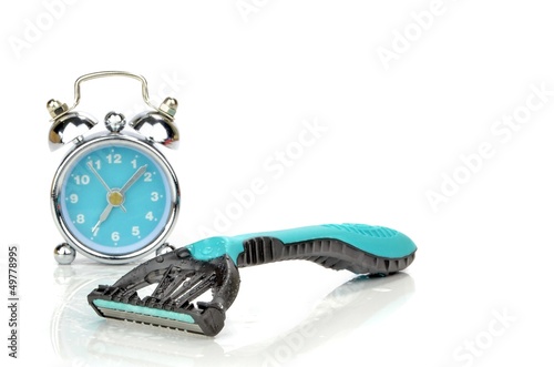 Photo: A disposable razor next to a mini alarm clock. Morning routine A disposable razor next to a mini alarm clock. Morning routine