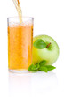 Pouring apple juice into a glass, green juicy apples with green