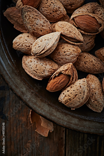 Photo: Almonds with shell on a ceramic plate Almonds with shell on a ceramic plate