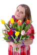 Cute child girl gives bouquet of tulip flowers