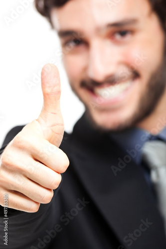 Photo: Businessman doing ok sign isolated on white Businessman doing ok sign isolated on white