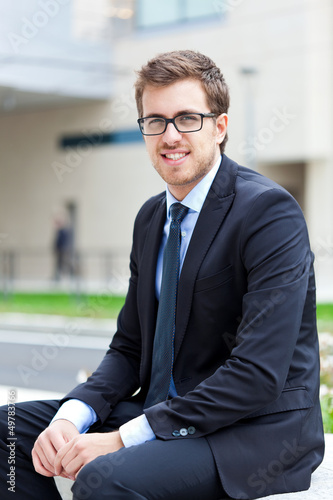 Photo: Businessman sitting outdoor Businessman sitting outdoor