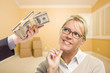 Woman Being Handed Stacks of Money in Empty Room