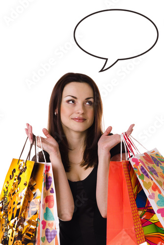 Photo: Woman with shopping bags thinking/dreaming about something Woman with shopping bags thinking/dreaming about something