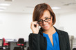Smiling woman holding her eyeglasses