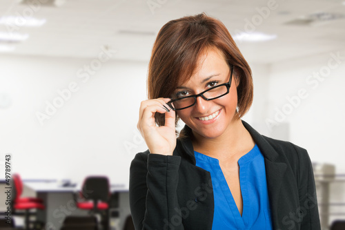 Photo: Smiling woman holding her eyeglasses Smiling woman holding her eyeglasses