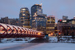 Calgary skyline and peace bridge at night.