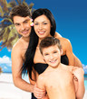 Happy family with child at tropical beach