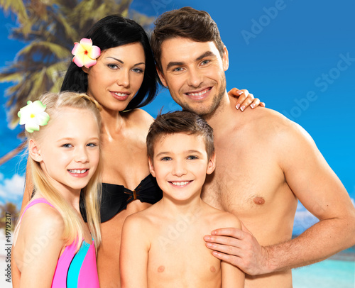 Photo: Happy family with two children at tropical beach Happy family with two children at tropical beach