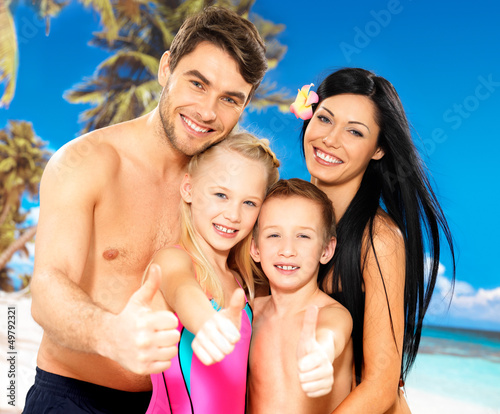 Photo: Happy smiling family with thumbs up sign Happy smiling family with thumbs up sign