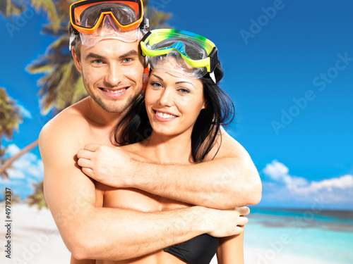 Photo: fun beautiful couple at tropical beach with swimming mask fun beautiful couple at tropical beach with swimming mask